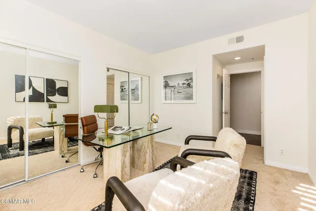 a living room with furniture a flat screen tv and a large window
