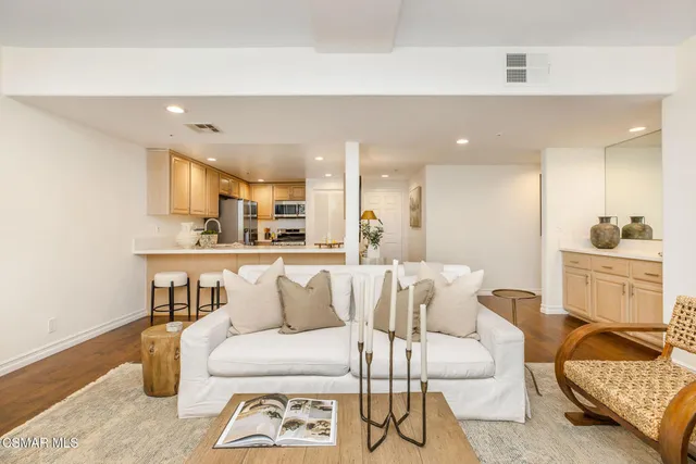 a living room with furniture and kitchen view