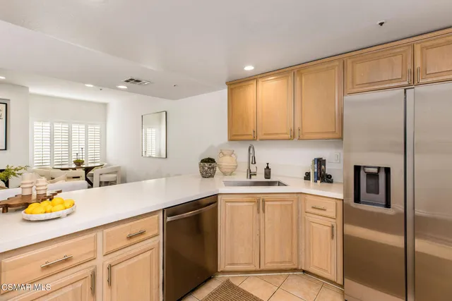 a kitchen with sink cabinets and refrigerator