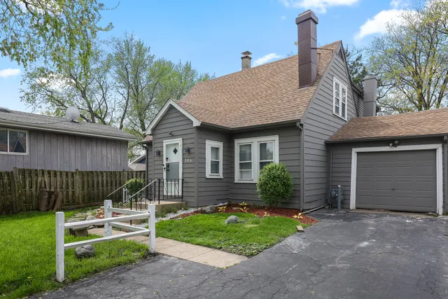 a view of a house with a yard and plants