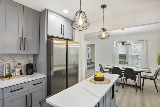 a kitchen with refrigerator and cabinets