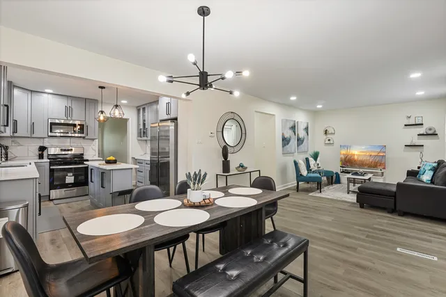 a view of a dining room with furniture and wooden floor