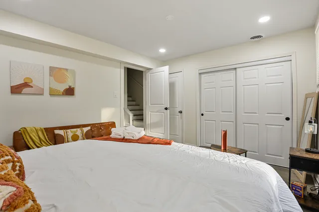 a bedroom with a bed and wooden floor