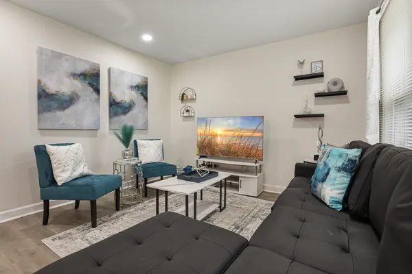 a living room with furniture and a flat screen tv