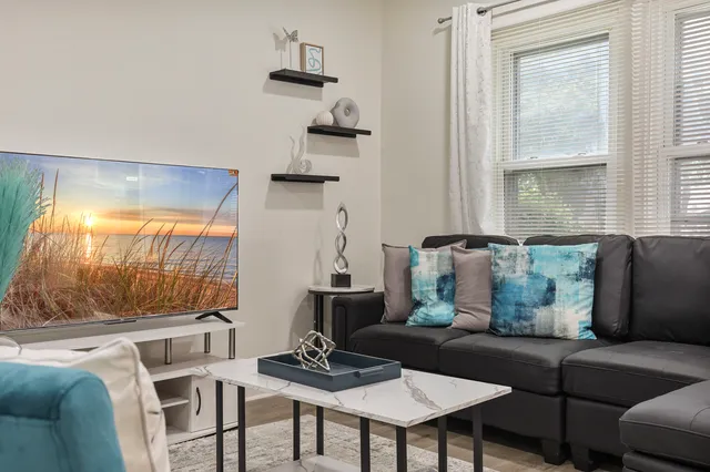 a living room with furniture and a large window