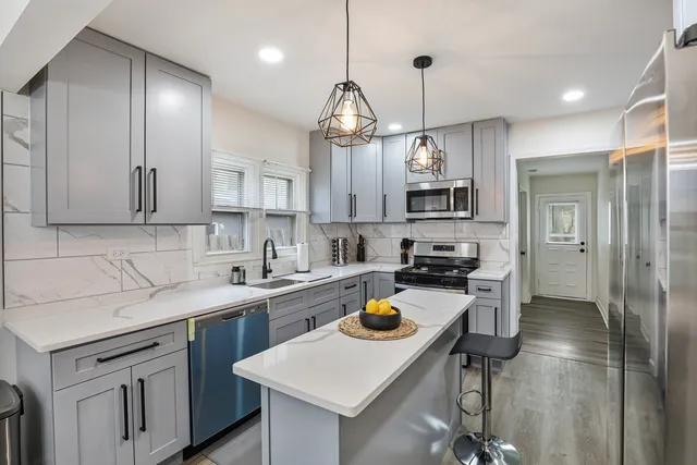 a kitchen with a sink a stove and cabinets
