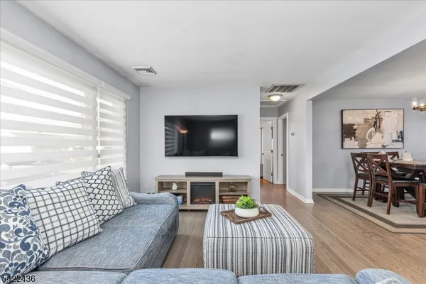 a living room with fireplace furniture and a flat screen tv
