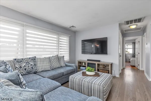 a living room with furniture and kitchen view
