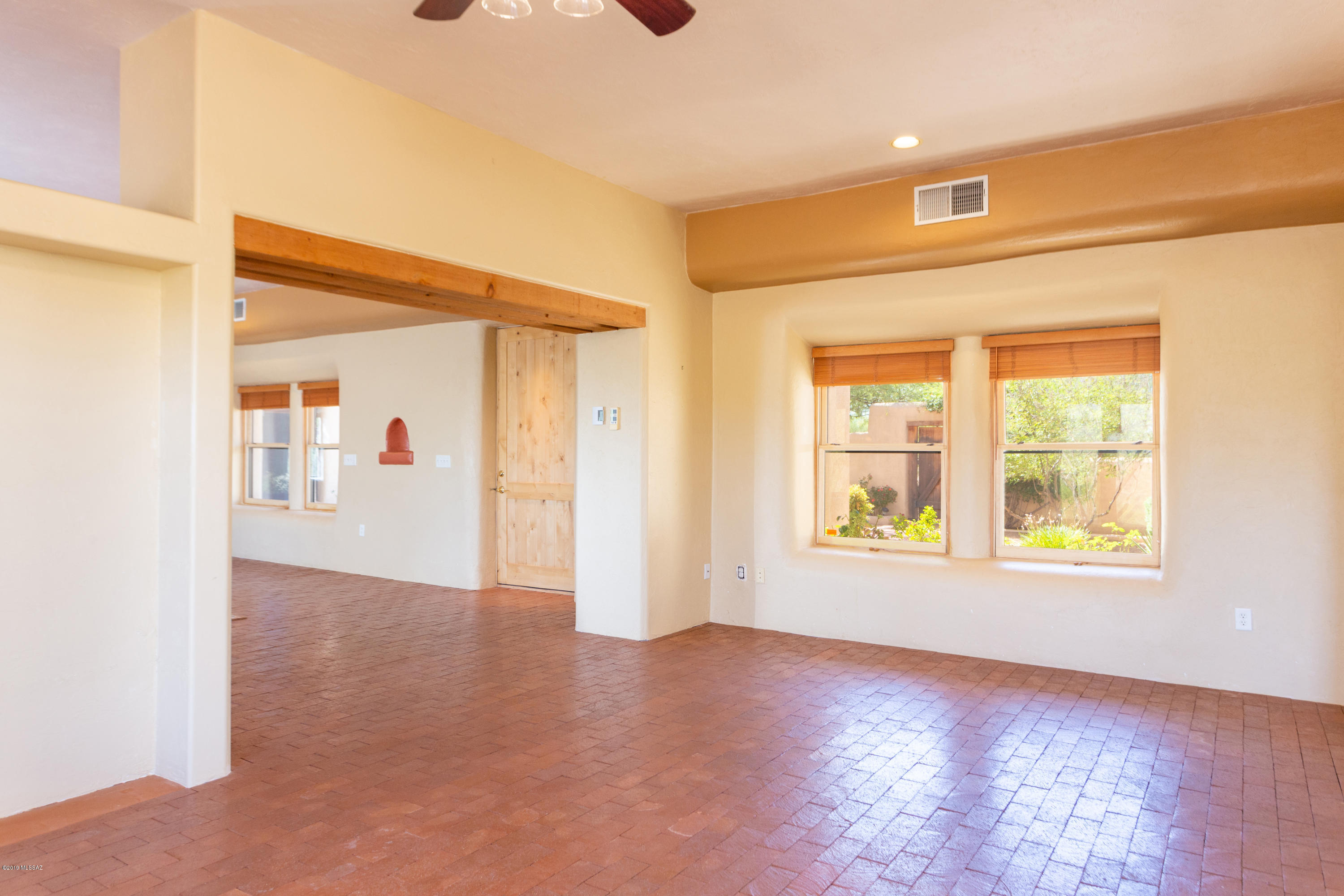79 Camino Talavera Rio Rico, AZ 85648 - Photo 19 of 50 an empty room with wooden floor and windows