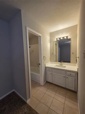 an empty room with a ceiling fan and window