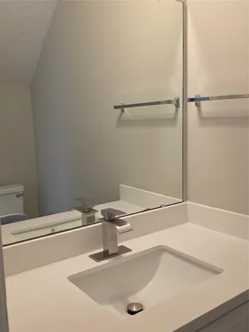 a view of a kitchen with a sink and a chandelier