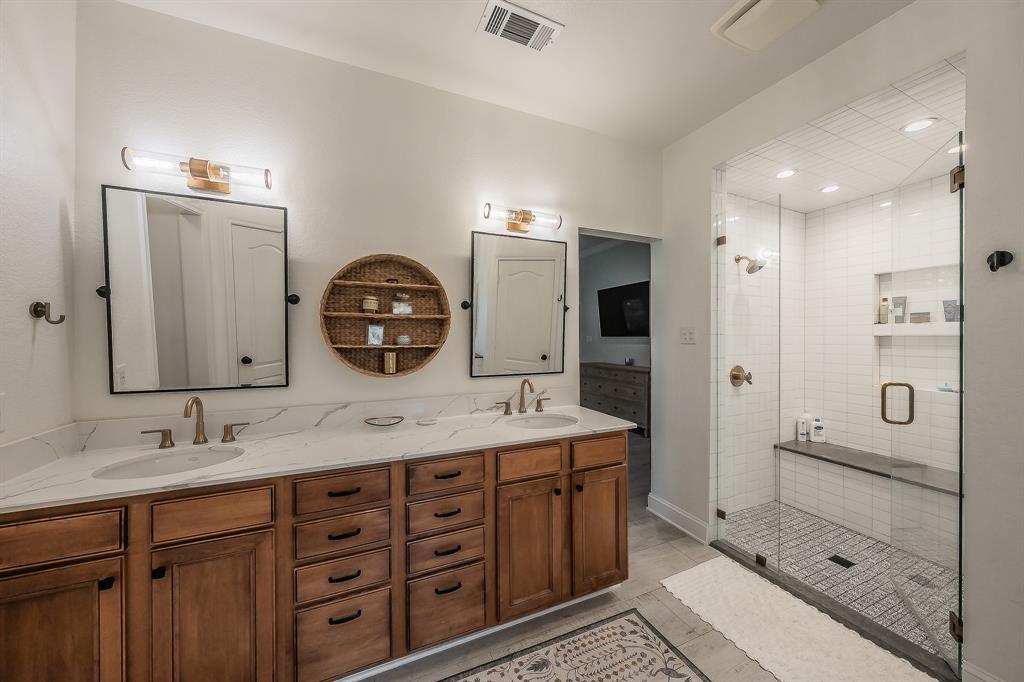 115 Pheasant Run Road Argyle, TX 76226 - Photo 16 of 40 a bathroom with a shower sink double and mirror