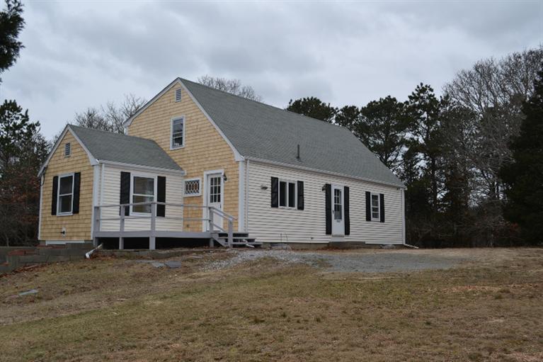 1755 Bridge Road Eastham, MA 02642 - Photo 1 of 10 a front view of a house with a yard