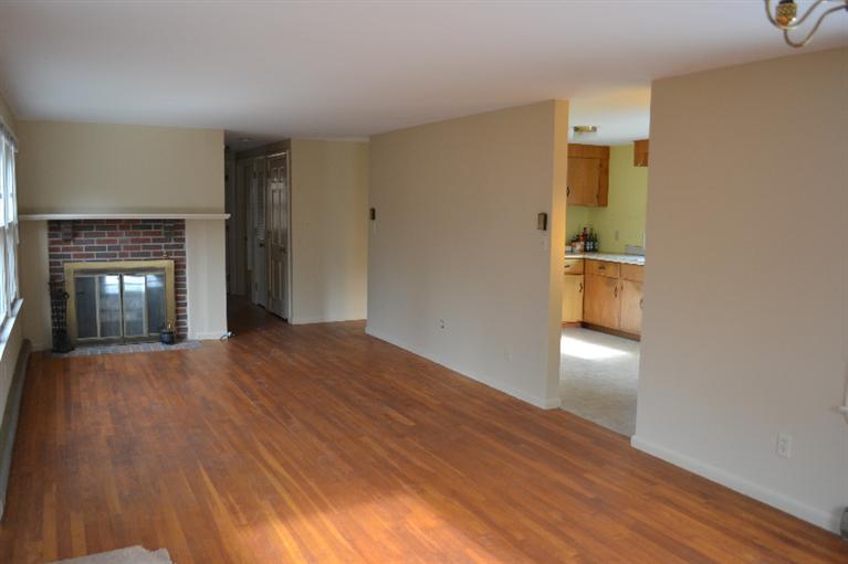 1755 Bridge Road Eastham, MA 02642 - Photo 3 of 10 a view of empty room with wooden floor and fireplace