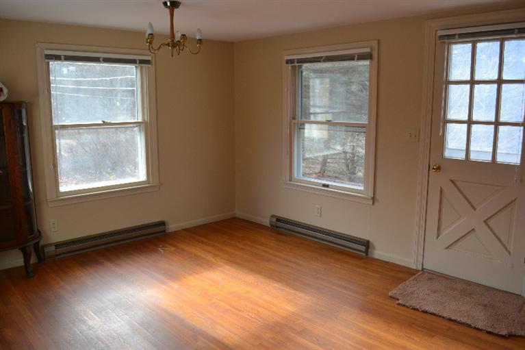 1755 Bridge Road Eastham, MA 02642 - Photo 4 of 10 a view of an empty room with wooden floor and a window