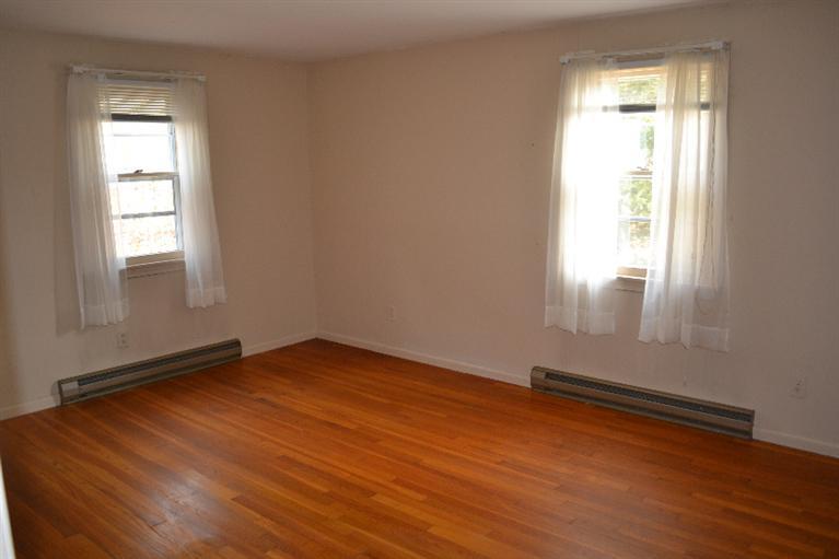 1755 Bridge Road Eastham, MA 02642 - Photo 8 of 10 an empty room with wooden floor and windows
