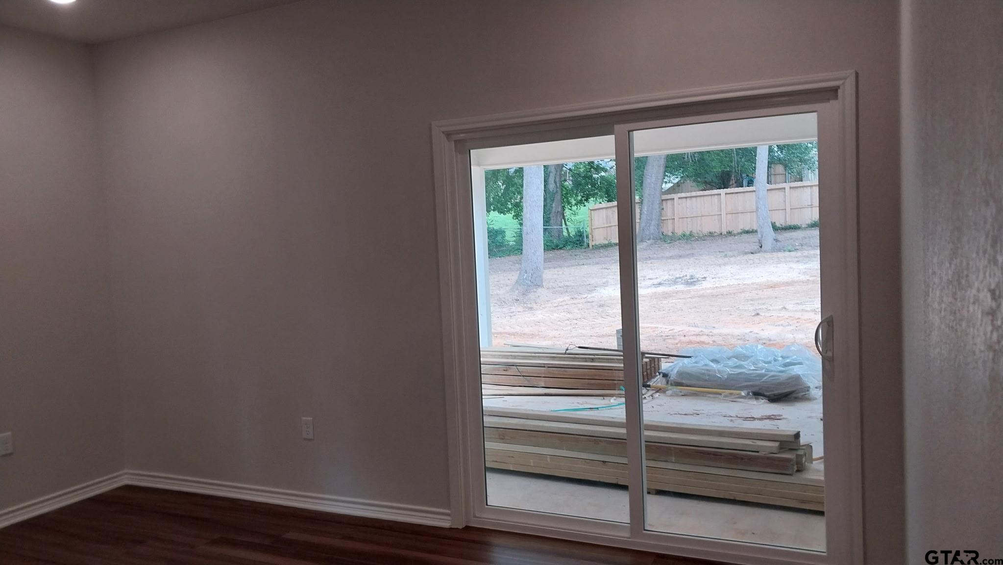 1262 George Richey Road Gladewater, TX 75647 - Photo 9 of 22 a view of empty room with wooden floor and fan