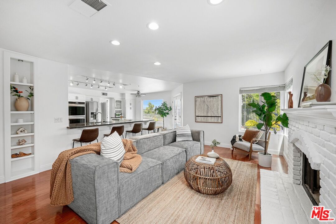24006 Briardale Way Newhall, CA 91321 - Photo 11 of 34 a living room with furniture fireplace and a flat screen tv