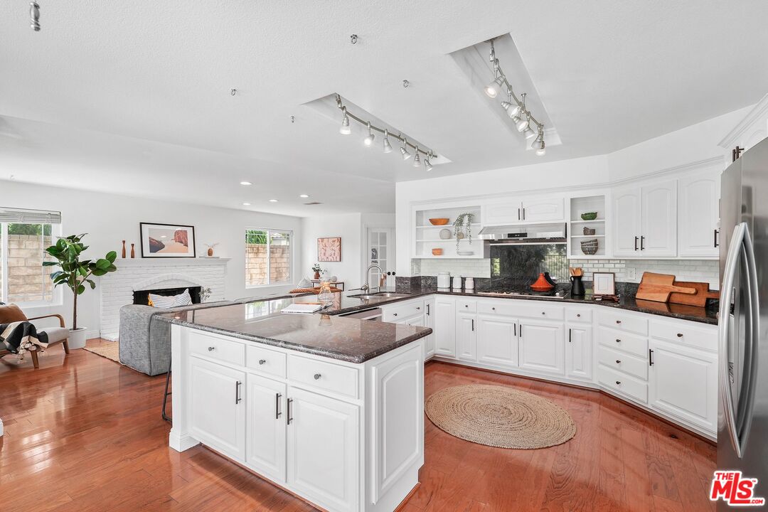 24006 Briardale Way Newhall, CA 91321 - Photo 14 of 34 a kitchen with granite countertop a sink appliances cabinets and furniture