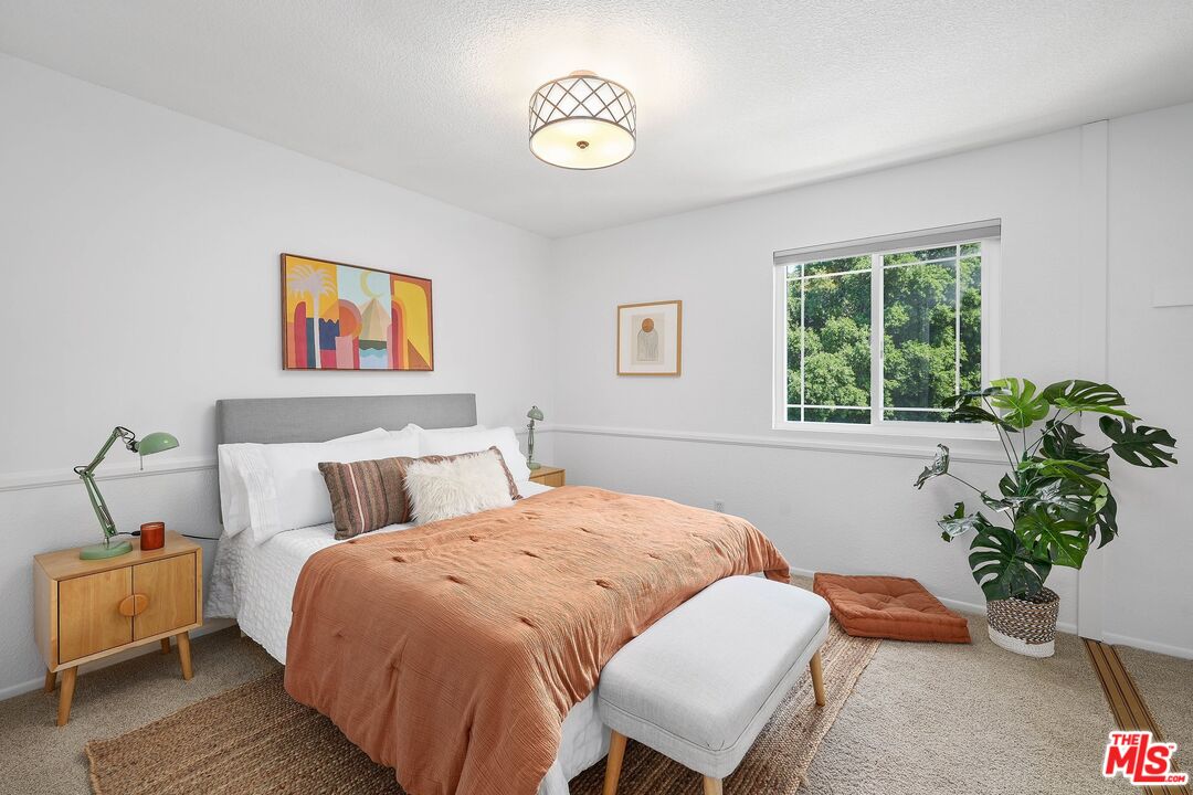 24006 Briardale Way Newhall, CA 91321 - Photo 17 of 34 a bedroom with a bed and a potted plant