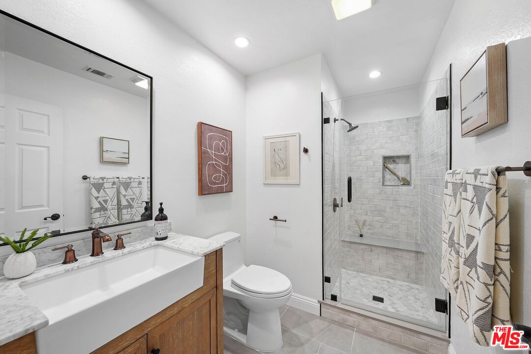 24006 Briardale Way Newhall, CA 91321 - Photo 18 of 34 a bathroom with a sink a toilet and shower