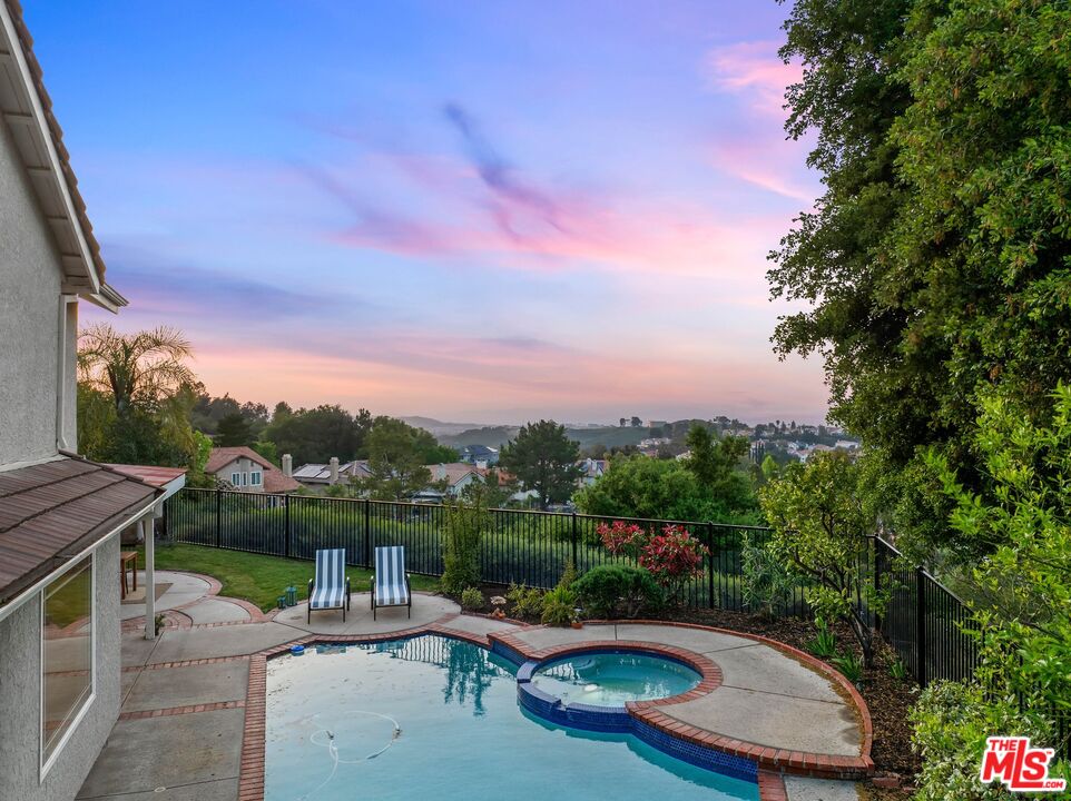 24006 Briardale Way Newhall, CA 91321 - Photo 31 of 34 a view of a swimming pool with a patio and a yard