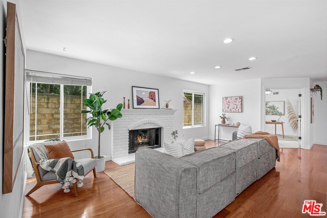 24006 Briardale Way Newhall, CA 91321 - Photo 9 of 34 a living room with furniture and a fireplace