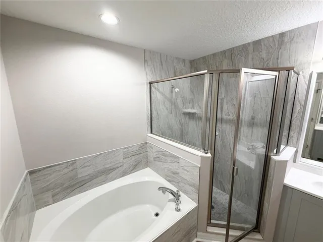 a bathroom with a bathtub and a shower