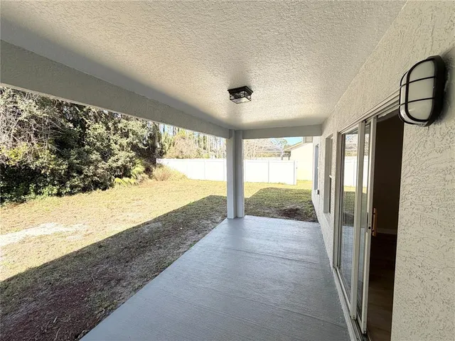 a view of a white house with a yard