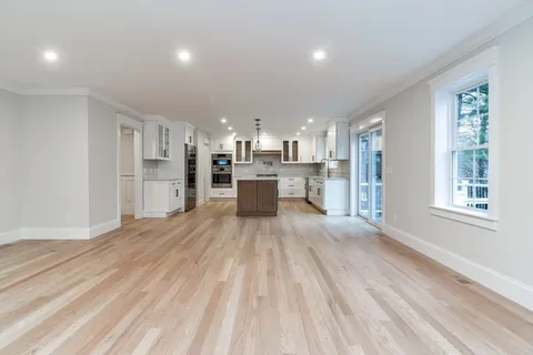 a large kitchen with a lot of counter space and stainless steel appliances