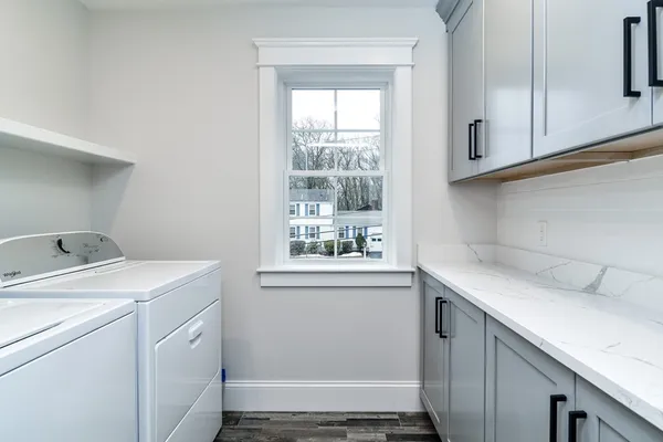 a utility room with cabinets washer and dryer