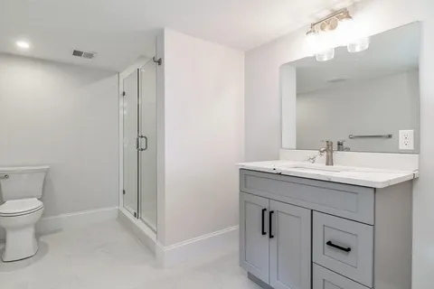 a bathroom with a sink toilet and shower