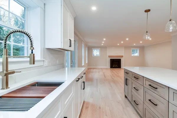 a kitchen with stainless steel appliances granite countertop a sink and a stove