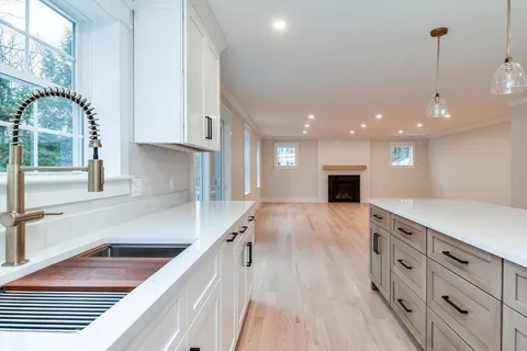 a kitchen with stainless steel appliances granite countertop a sink and a stove