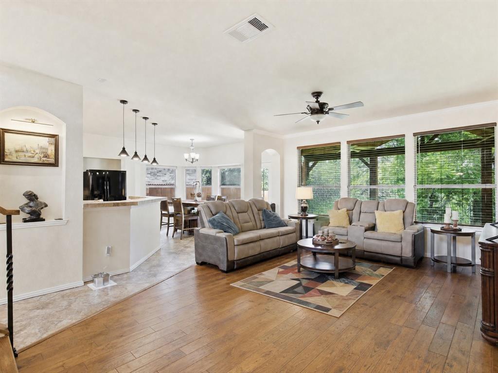 4008 Falcon Ridge Drive Haltom City, TX 76137 - Photo 14 of 40 Spacious living area featuring wood-finish flooring and abundant natural light from multiple windows