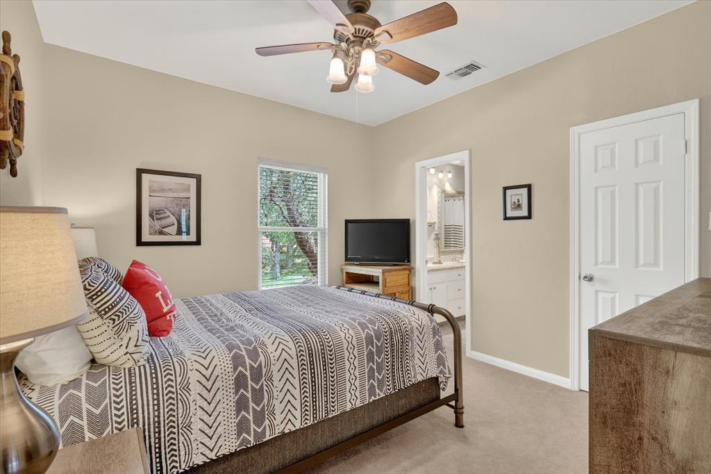 8877 Random Road Fort Worth, TX 76179 - Photo 23 of 40 a bedroom with a large bed and a flat screen tv