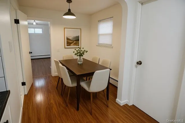 a view of a dining room with furniture and wooden floor