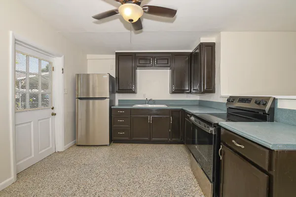 a kitchen with a refrigerator and a sink
