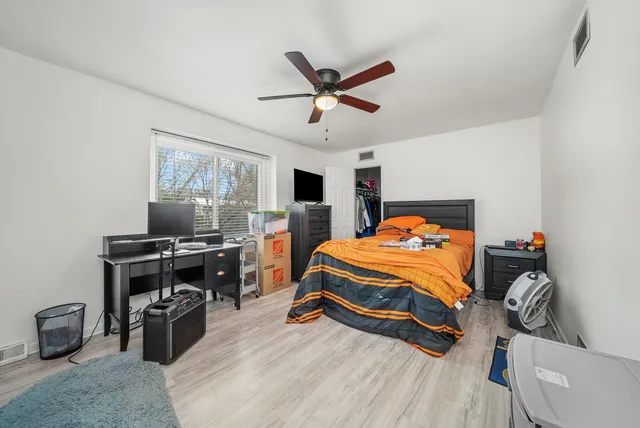 a bedroom with a bed and a chandelier