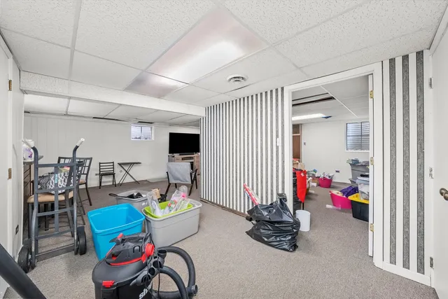 a living room with lots of furniture and gym equipment