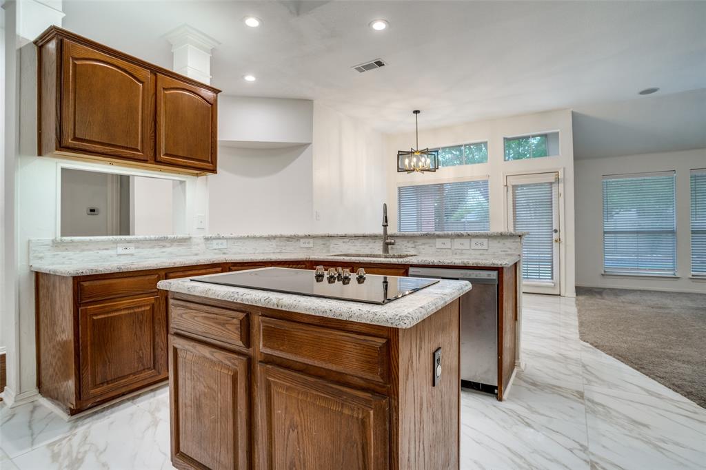 901 Autumn Ridge Drive McKinney, TX 75072 - Photo 12 of 24 a kitchen with granite countertop a sink stove and cabinets
