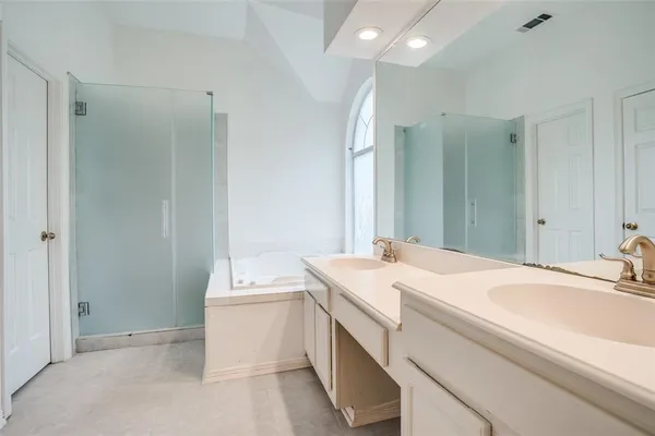 an empty room with closet and a chandelier fan