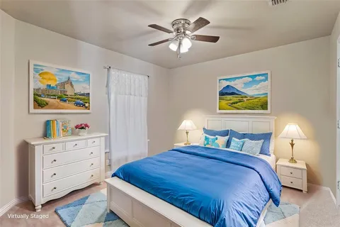 a bedroom with a bed and painting on the wall