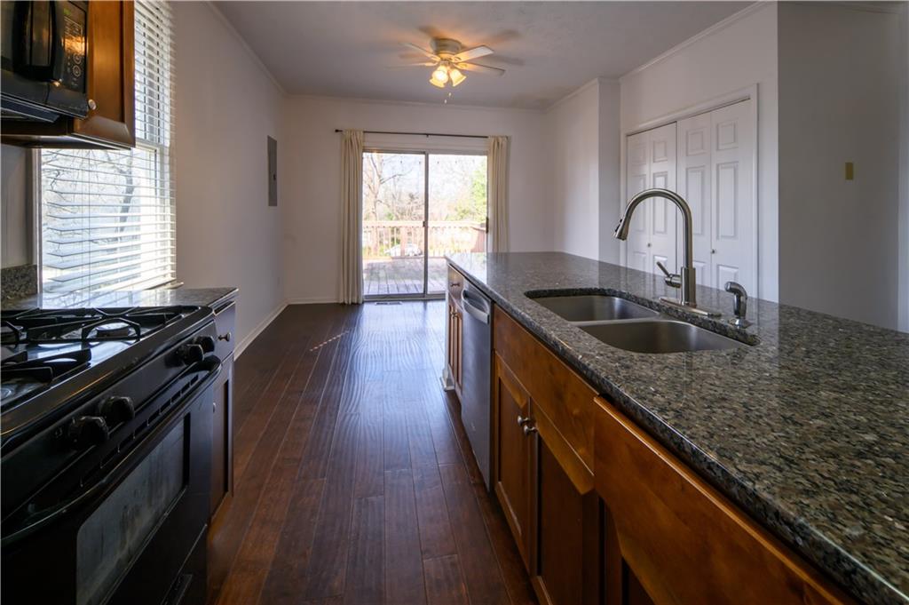 2881 Parrott Avenue Northwest Atlanta, GA 30318 - Photo 11 of 32 a kitchen with granite countertop a stove and a sink