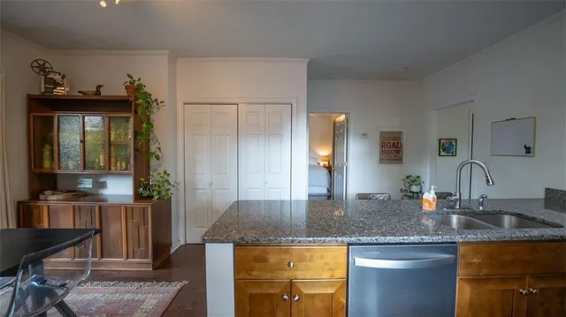 a kitchen with granite countertop a sink and cabinets