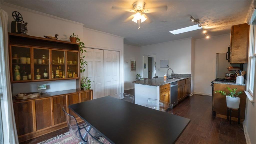 2881 Parrott Avenue Northwest Atlanta, GA 30318 - Photo 12 of 32 a kitchen with kitchen island granite countertop a sink counter top space and stainless steel appliances