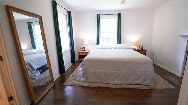 a bedroom with a bed and a mirror