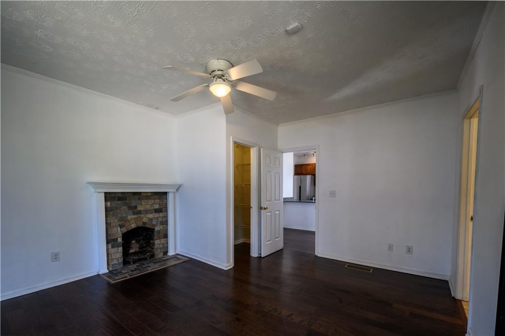 2881 Parrott Avenue Northwest Atlanta, GA 30318 - Photo 14 of 32 wooden floor in an empty room with a window