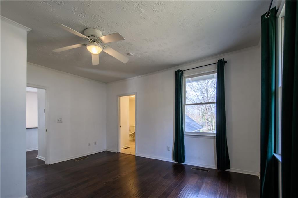 2881 Parrott Avenue Northwest Atlanta, GA 30318 - Photo 15 of 32 a view of an empty room with wooden floor and a window