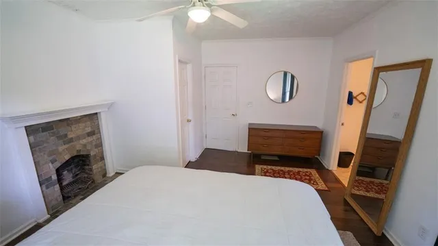 a bedroom with a bed and a fireplace